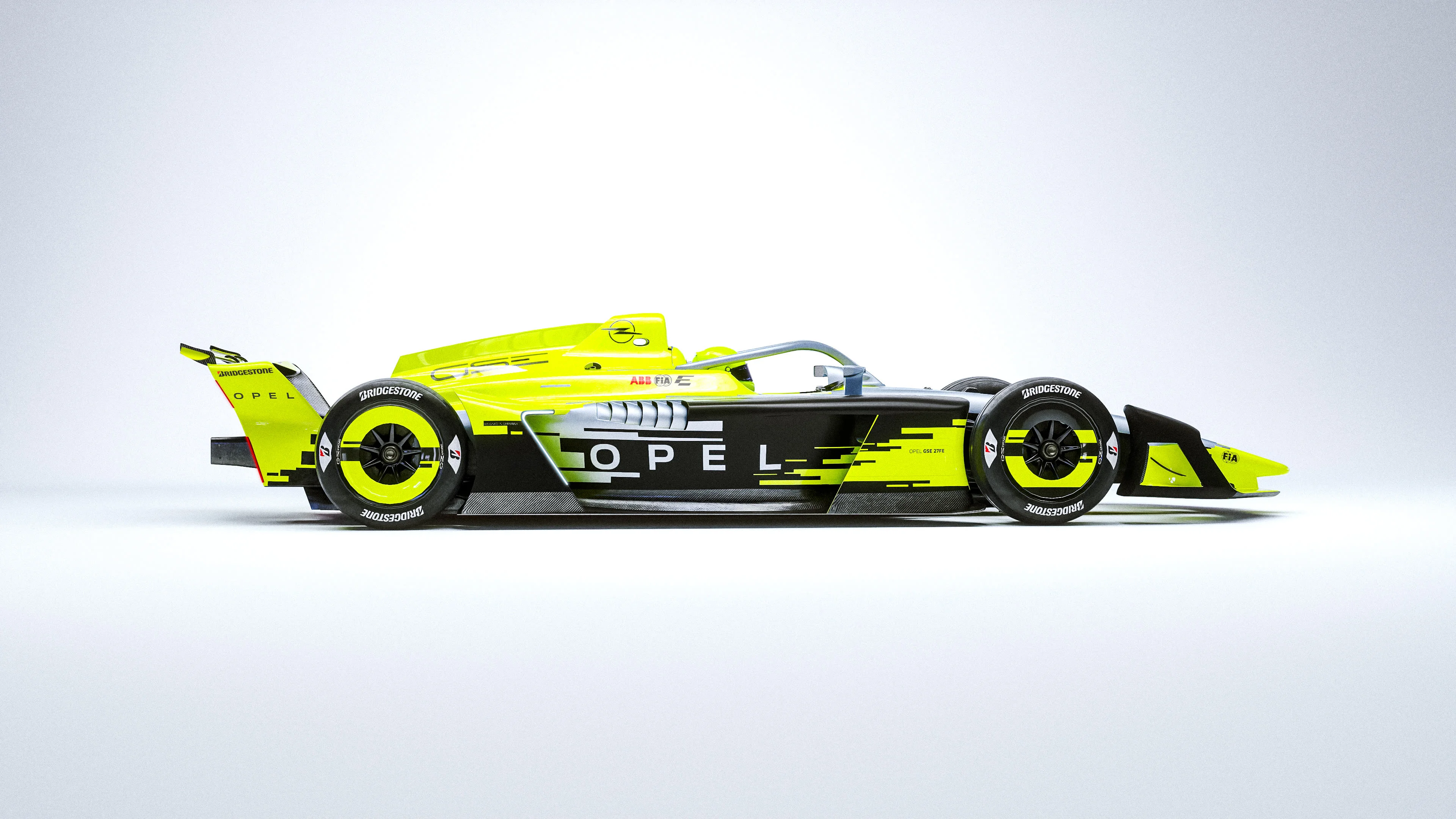 Left side profile of the yellow, silver and black Opel GSE 27FE Formula E car on a plain white studio background, with large "OPEL" lettering on the sidepod.